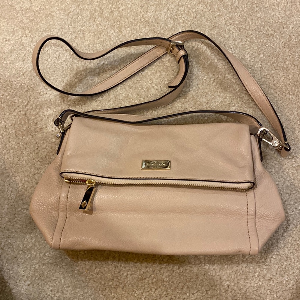 Blush kate spade cross body bag with bright pink liner